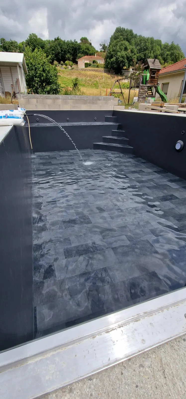 Bassin neuf près de Grenoble avec membrane gris anthracite et fond texturé